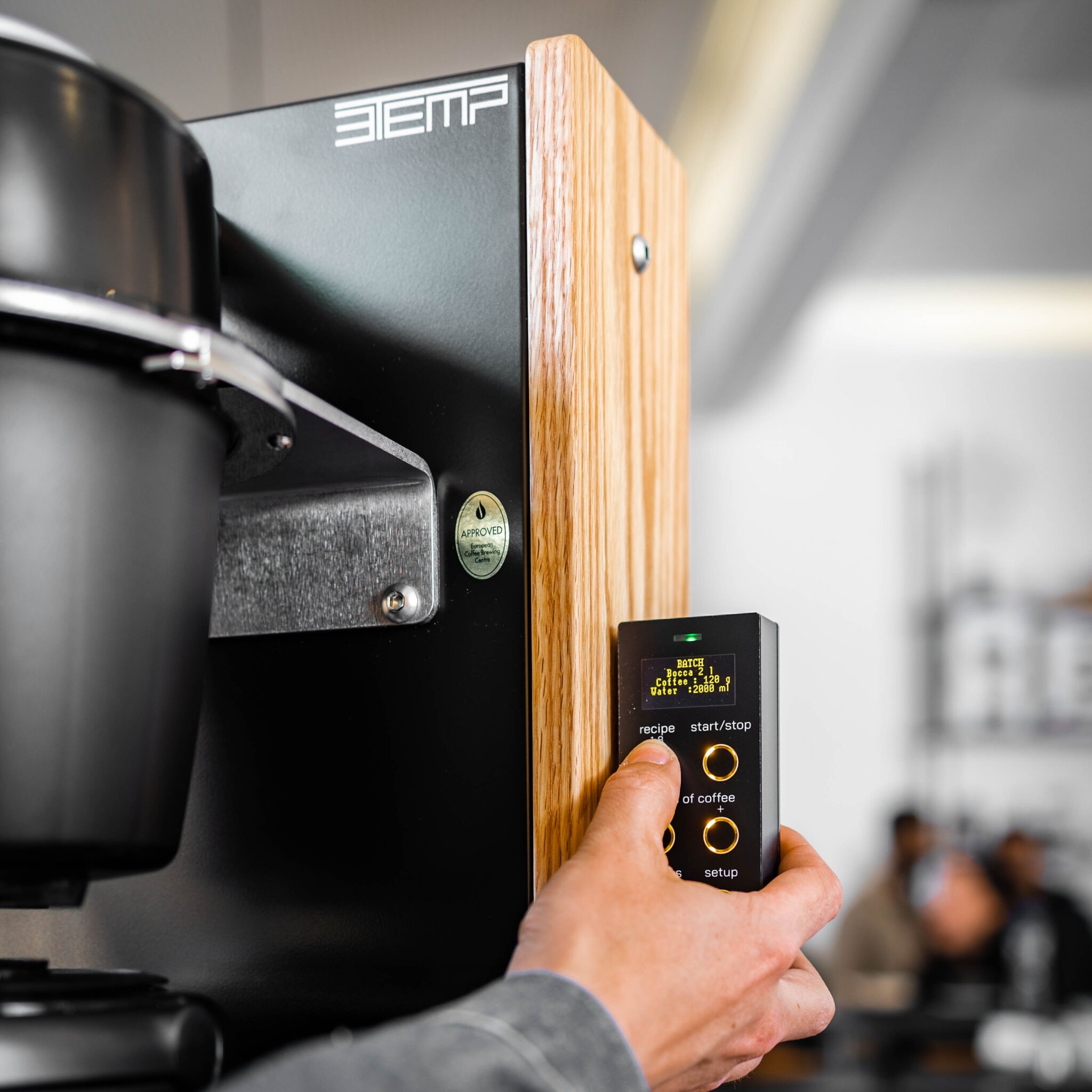 A barista selects a recipe on a 3TEMP brewer
